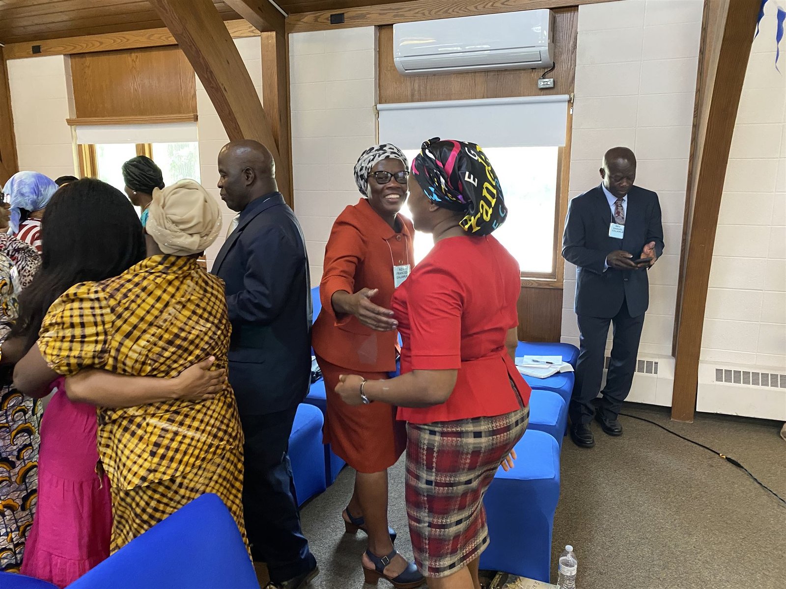 Two members embrace during a TRANSCEA worship gathering